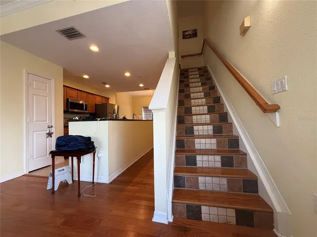 a view of entryway and hall with wooden floor