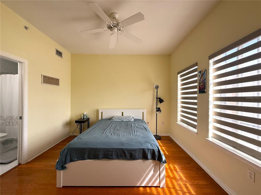 120 South Obrien Street Tampa, FL 33609 - Photo 17 of 47 a view of a bedroom with a bed and wooden floor
