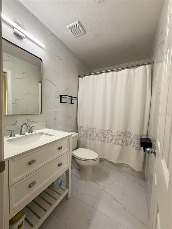 120 South Obrien Street Tampa, FL 33609 - Photo 18 of 47 a bathroom with a granite countertop sink toilet and shower