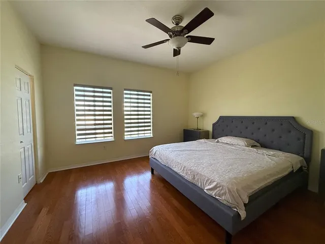 a bedroom with a large bed and a large window