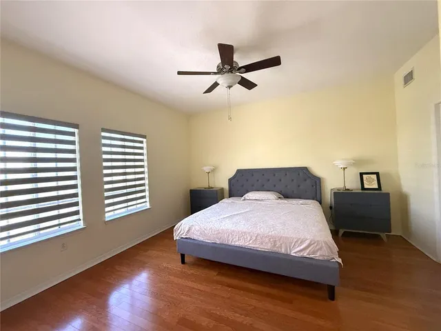 a bedroom with a bed and a night stand