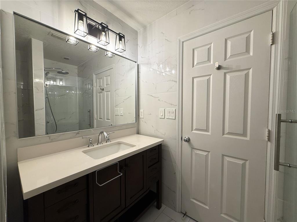 120 South Obrien Street Tampa, FL 33609 - Photo 24 of 47 a bathroom with a sink double vanity and a mirror