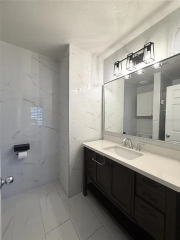 a bathroom with a double vanity sink and mirror