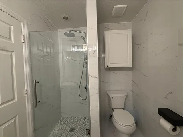 a bathroom with a toilet and shower