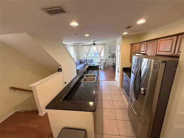 a kitchen with stainless steel appliances a refrigerator and a cabinets