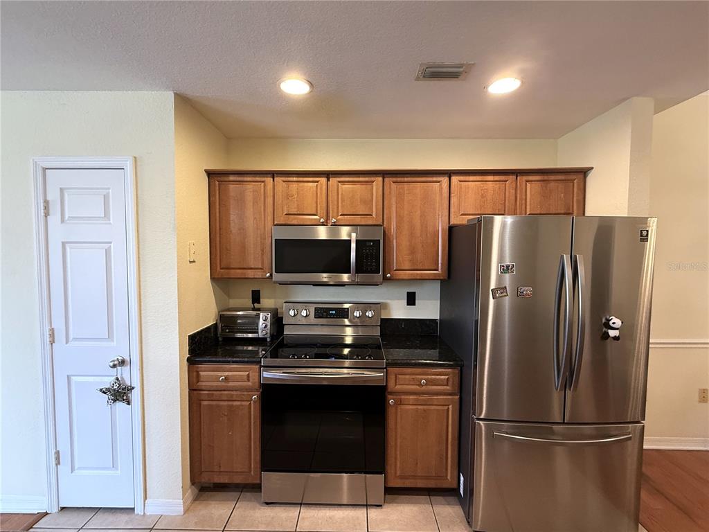 120 South Obrien Street Tampa, FL 33609 - Photo 7 of 47 a kitchen with stainless steel appliances granite countertop a refrigerator a stove a sink and a microwave
