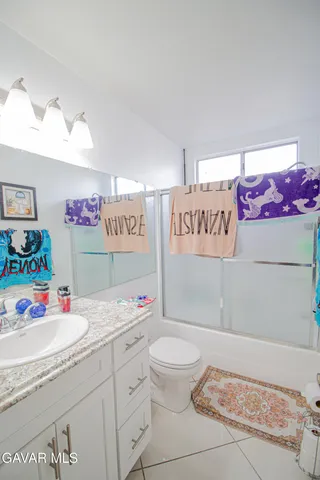 a bathroom with a sink mirror vanity and toilet