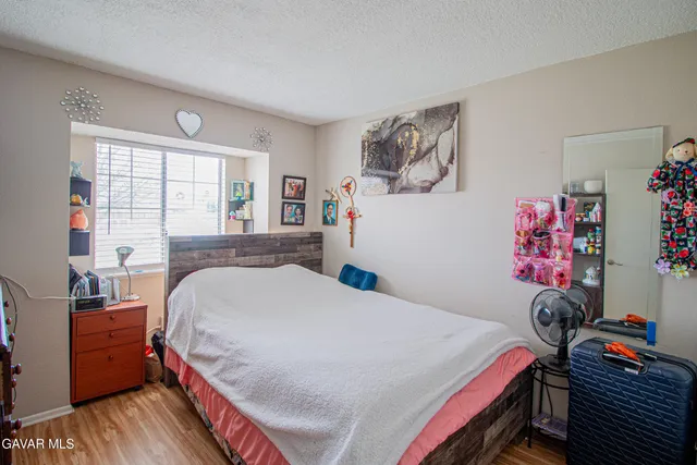 a bed room with a bed and a desk