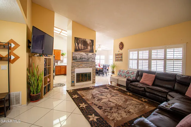a living room with furniture a rug and a fireplace