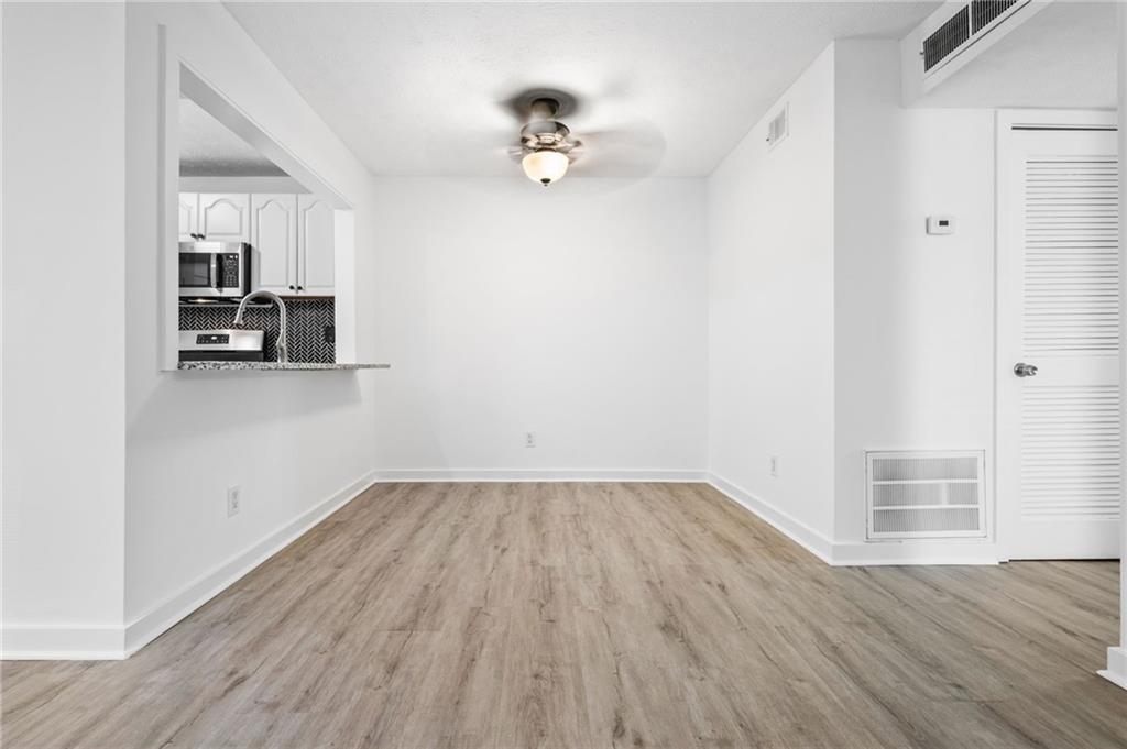 102 River Run Drive Atlanta, GA 30350 - Photo 16 of 28 a view of a kitchen with wooden floor and a ceiling fan