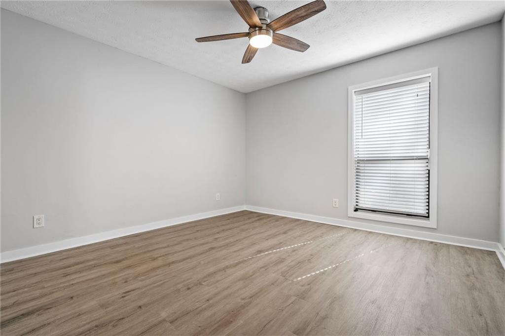 102 River Run Drive Atlanta, GA 30350 - Photo 18 of 28 a view of an empty room with wooden floor and a window
