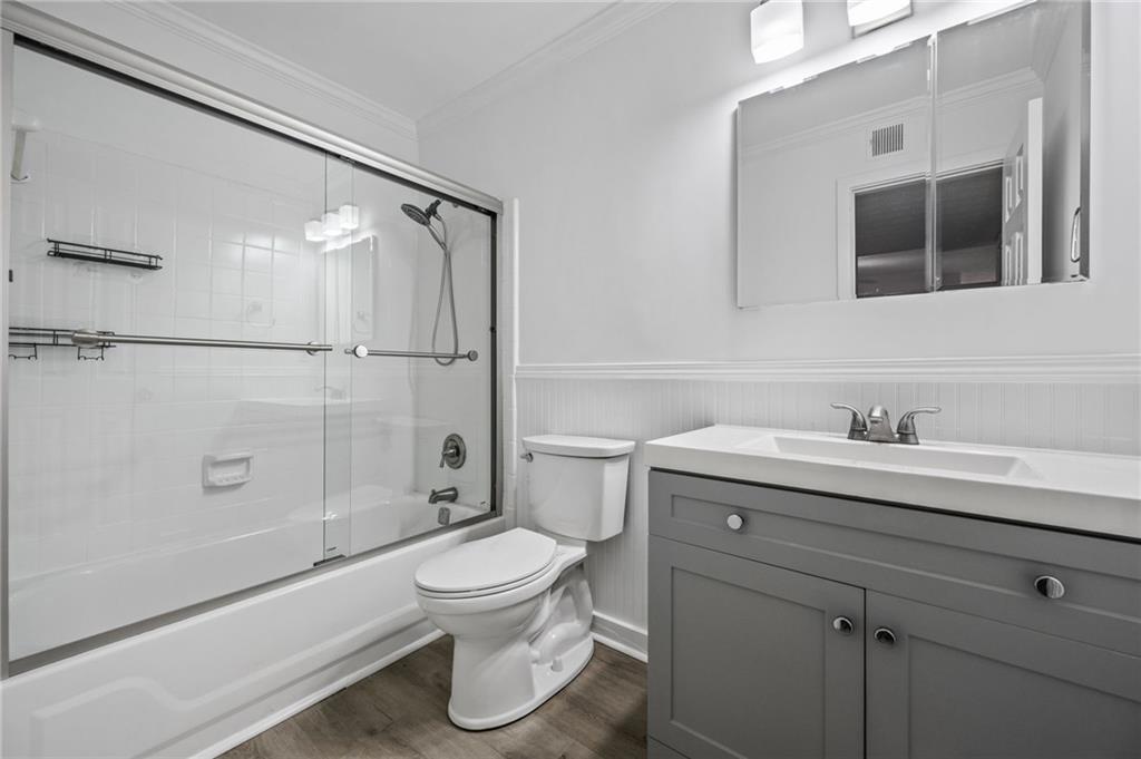 102 River Run Drive Atlanta, GA 30350 - Photo 20 of 28 a bathroom with a granite countertop sink toilet a mirror and shower