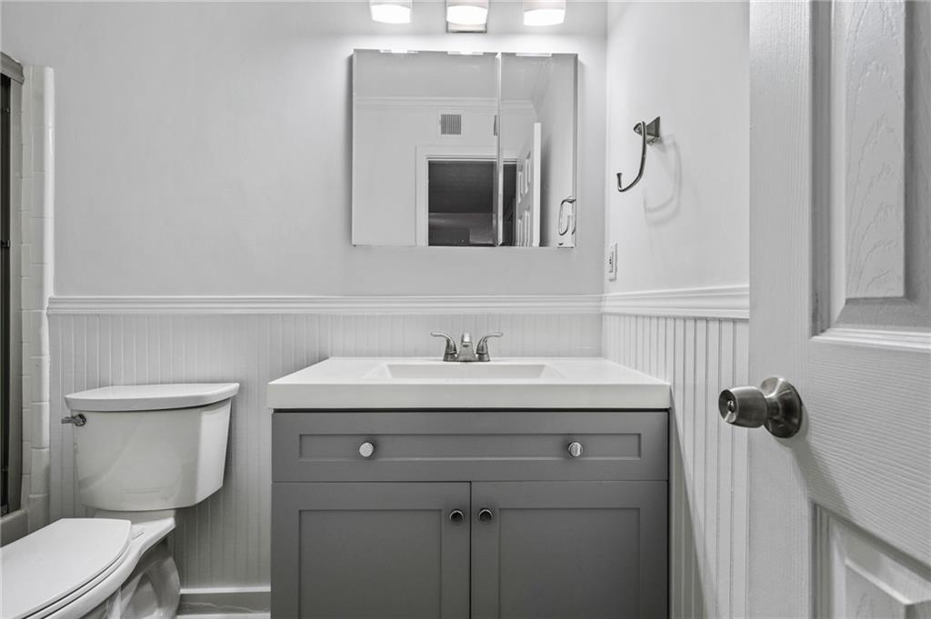 102 River Run Drive Atlanta, GA 30350 - Photo 21 of 28 a bathroom with a granite countertop toilet sink and mirror
