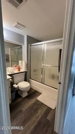 a bathroom with a toilet a sink and a shower