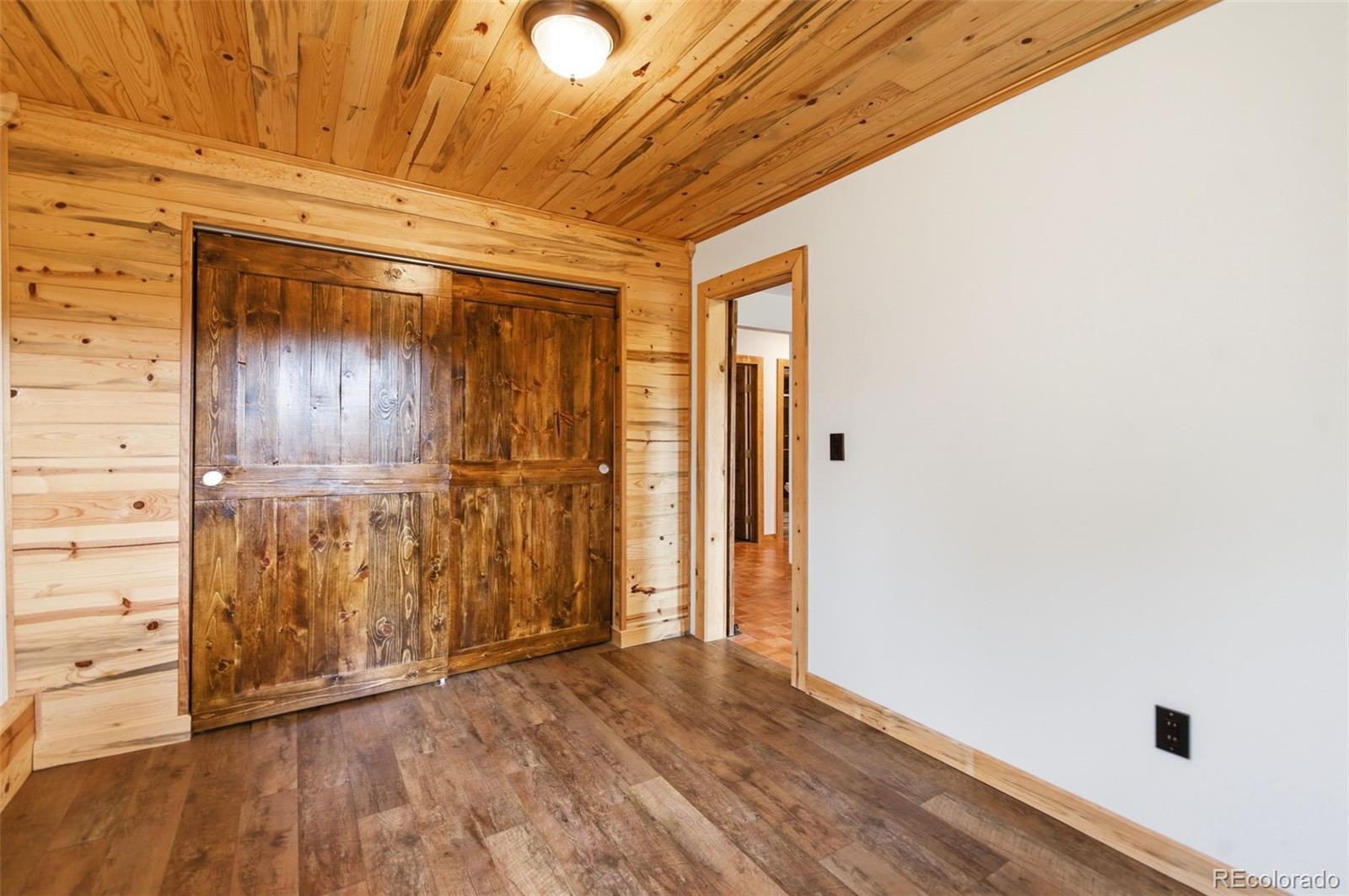 202 Badger Lane Bailey, CO 80421 - Photo 38 of 50 a view of empty room with wooden floor