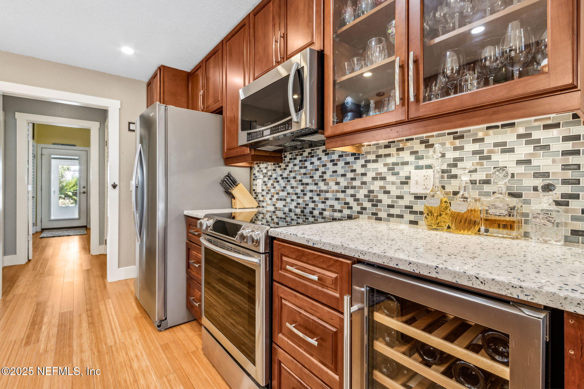 111 South 4th Street Fernandina Beach, FL 32034 - Photo 14 of 37 a kitchen with granite countertop a stove and a wooden floor