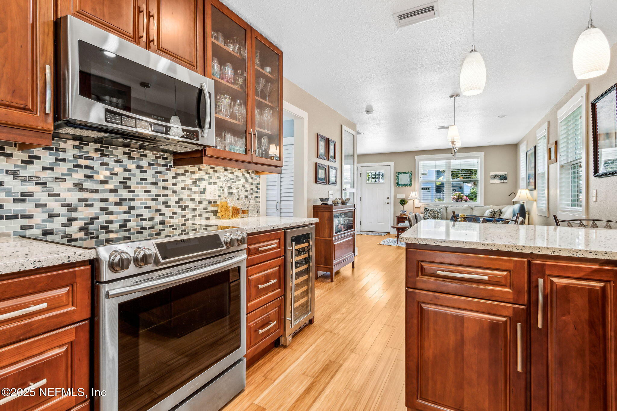 111 South 4th Street Fernandina Beach, FL 32034 - Photo 15 of 37 a kitchen with stainless steel appliances a stove a sink dishwasher a microwave oven with cabinets and wooden floor