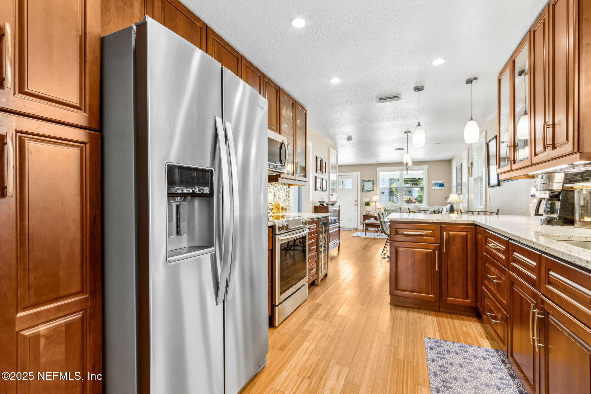 111 South 4th Street Fernandina Beach, FL 32034 - Photo 16 of 37 a kitchen with stainless steel appliances granite countertop a refrigerator oven a sink dishwasher and a refrigerator with wooden floor