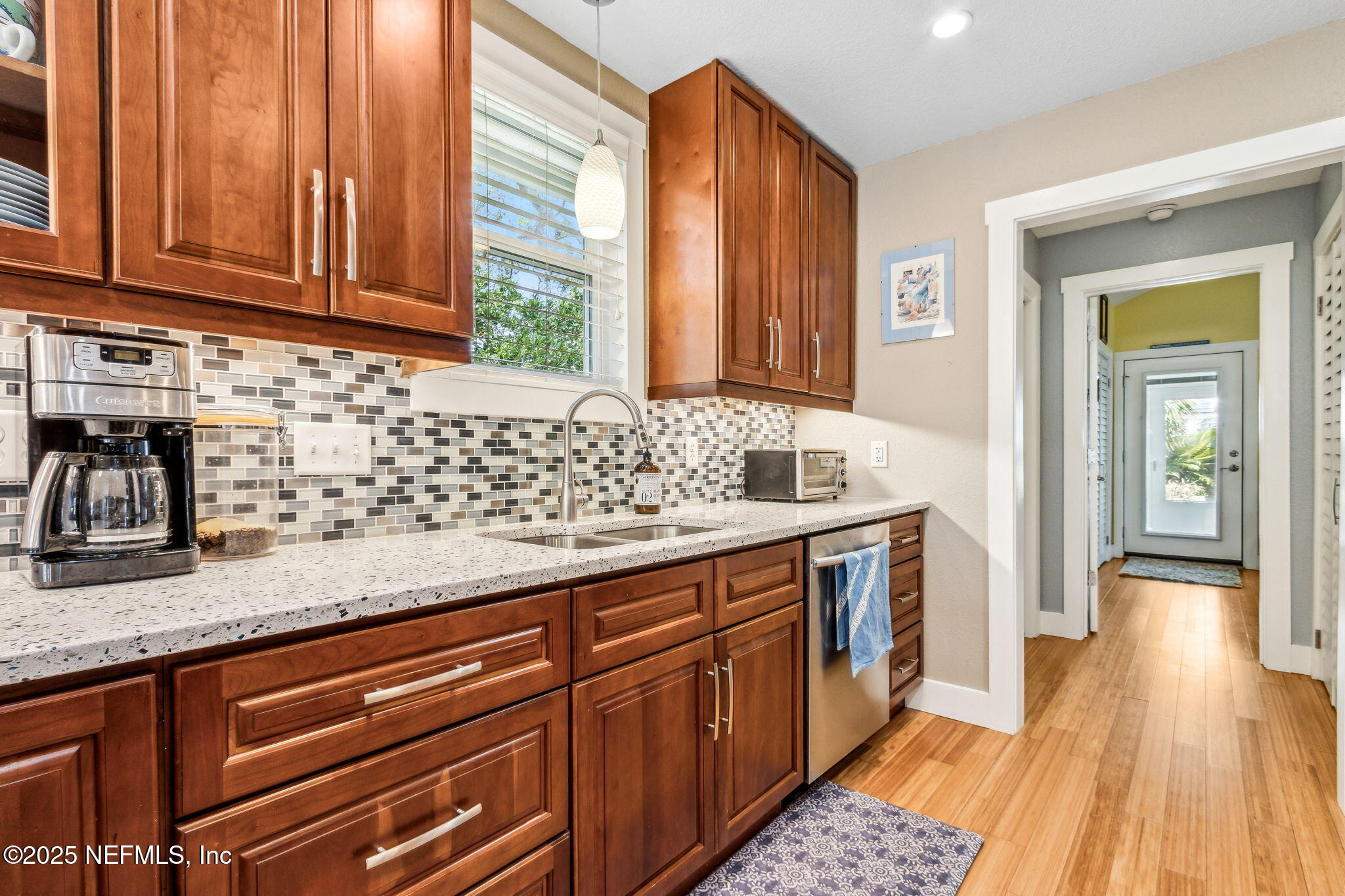 111 South 4th Street Fernandina Beach, FL 32034 - Photo 17 of 37 a kitchen with granite countertop stainless steel appliances a sink and cabinets