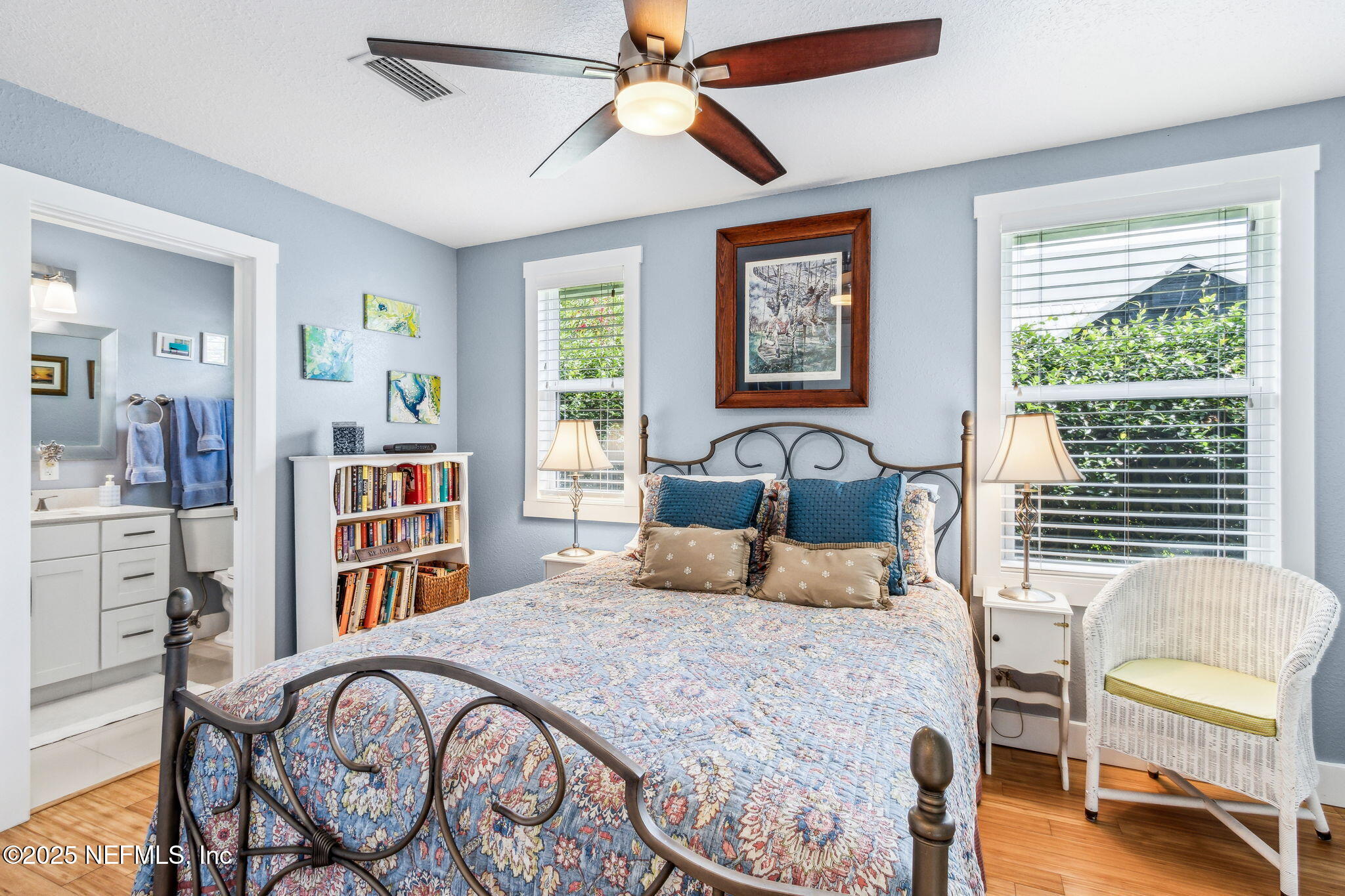 111 South 4th Street Fernandina Beach, FL 32034 - Photo 20 of 37 a bedroom with a bed a bookshelf and a large window