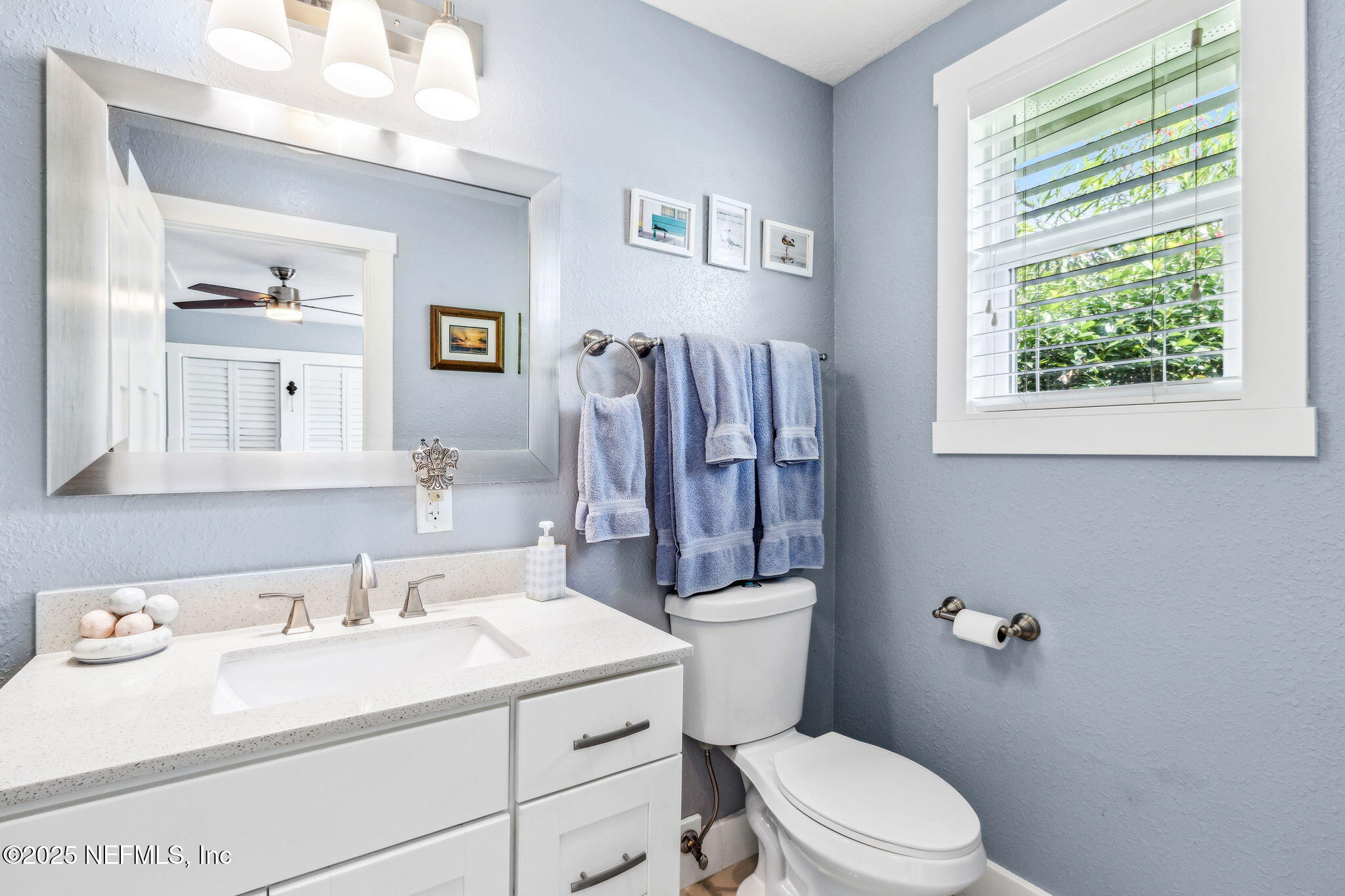111 South 4th Street Fernandina Beach, FL 32034 - Photo 22 of 37 a bathroom with a sink a toilet and a mirror