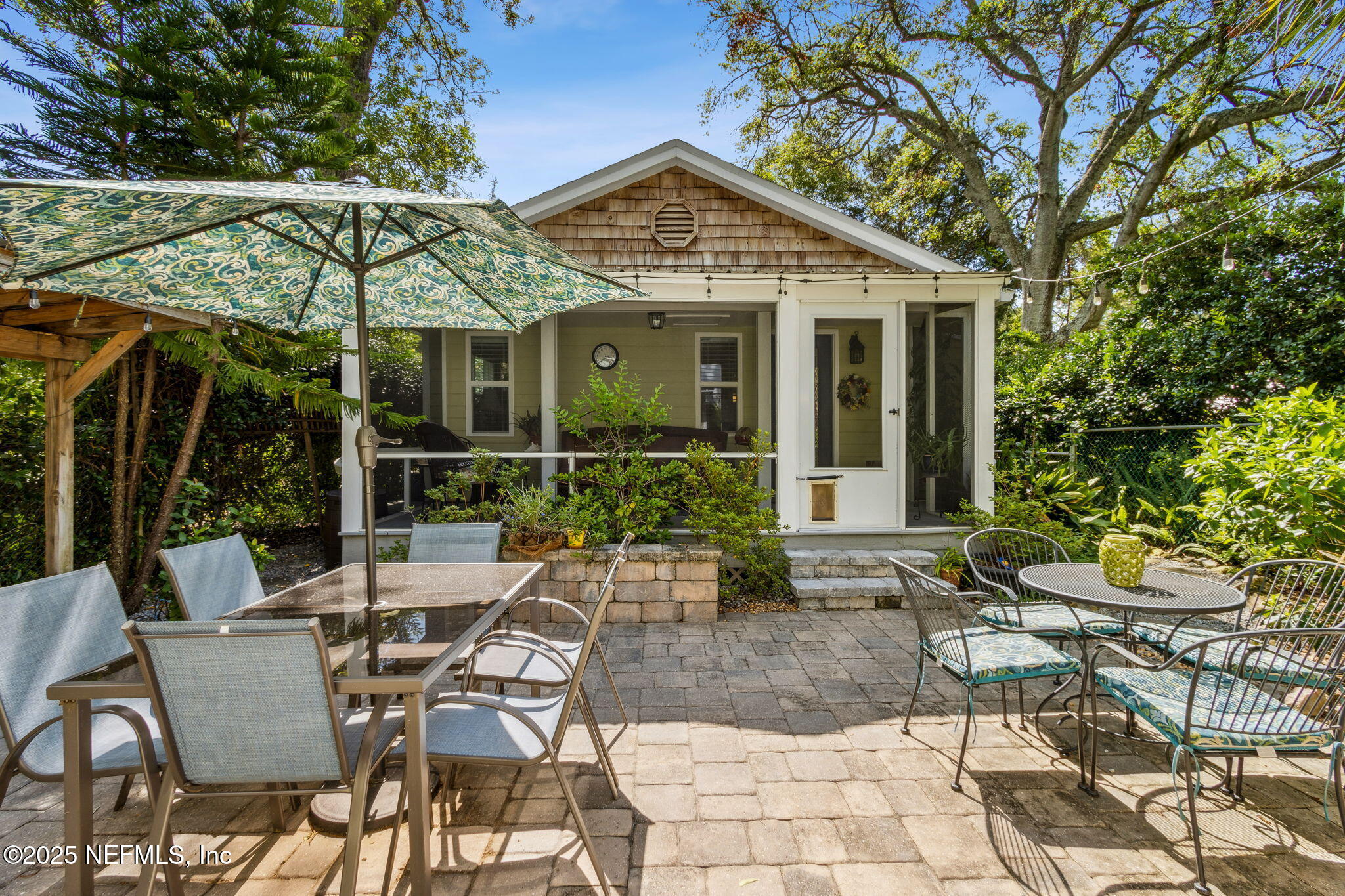 111 South 4th Street Fernandina Beach, FL 32034 - Photo 27 of 37 a view of a patio with table and chairs potted plants and large tree