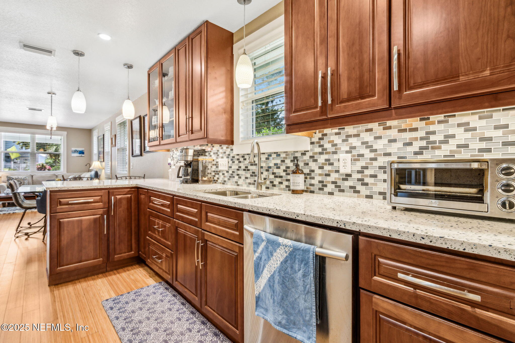 111 South 4th Street Fernandina Beach, FL 32034 - Photo 3 of 37 a kitchen with stainless steel appliances granite countertop wooden cabinets a sink and dishwasher