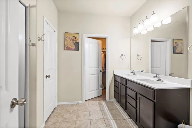 a bathroom with a double vanity sink mirror and