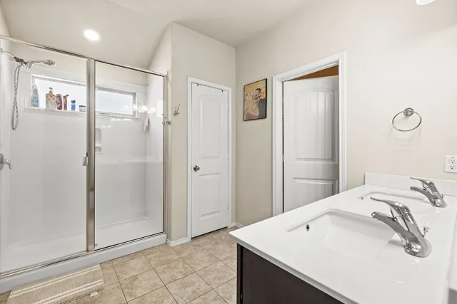 a bathroom with a sink a mirror and shower