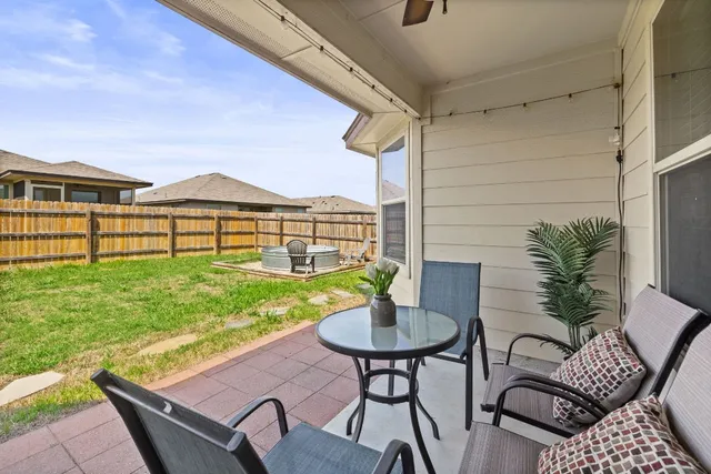 a view of a patio with a table and chairs