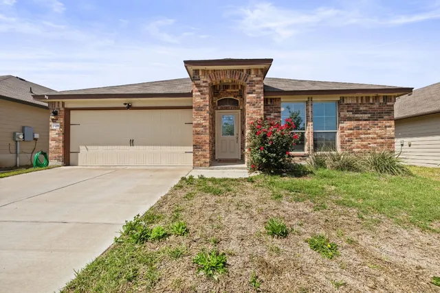 a front view of a house with a yard