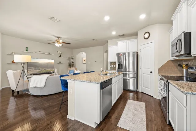 a kitchen with a stove a refrigerator and a sink