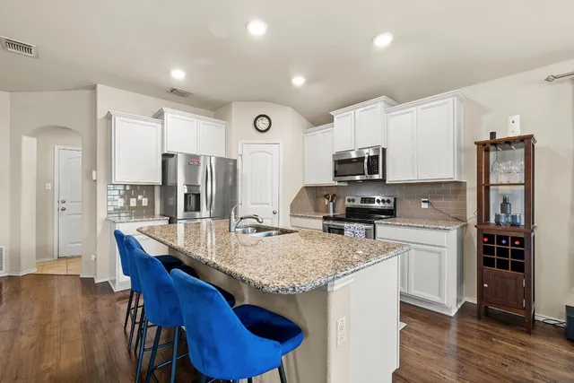 a kitchen with granite countertop counter space a sink appliances and cabinets