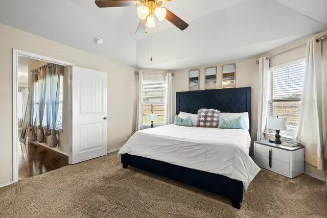 a bedroom with a bed and ceiling fan