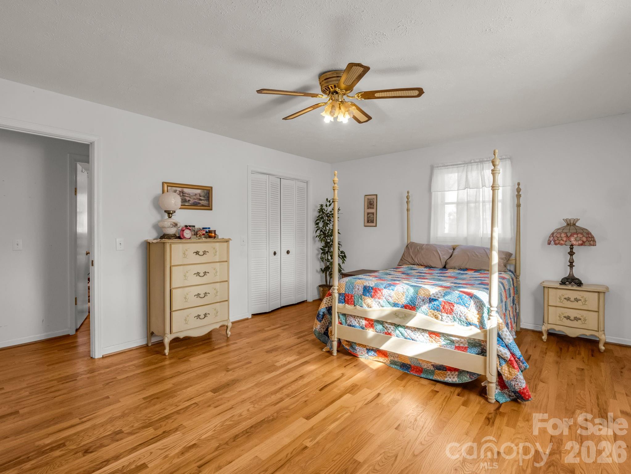 755 Mt Olivet Road Zirconia, NC 28790 - Photo 14 of 35 a bedroom with a bed and wooden floor