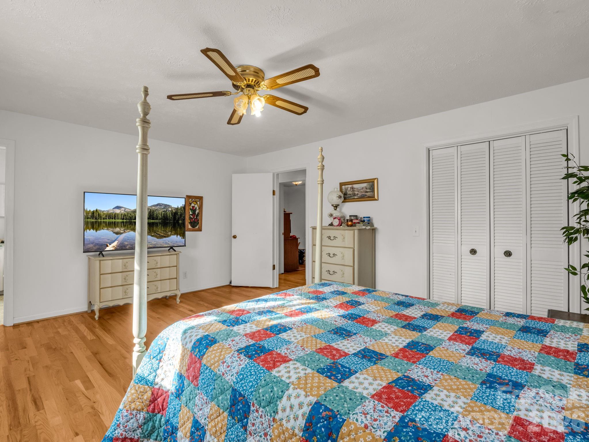 755 Mt Olivet Road Zirconia, NC 28790 - Photo 15 of 35 a bedroom with a bed and a chandelier