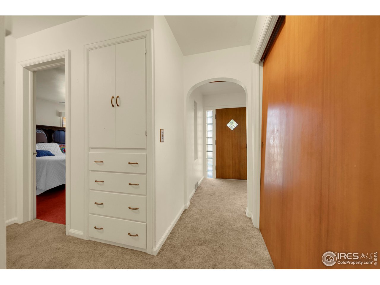 724 Carson Street Brush, CO 80723 - Photo 12 of 29 Hallway looking to front door, hallway built ins and main level bedroom
