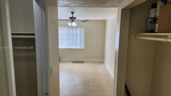 a view of an empty room with a bathroom