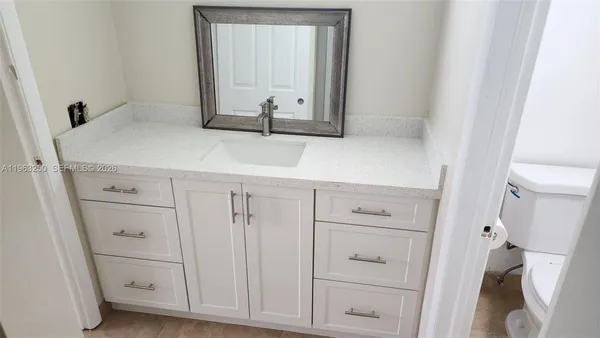 a white toilet sitting next to a bath tub