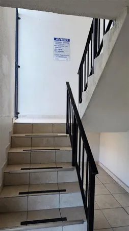 a dining room with furniture and a window