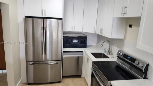 a kitchen with refrigerator and stove