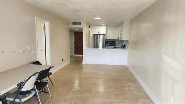 a kitchen with stainless steel appliances a refrigerator and a stove top oven
