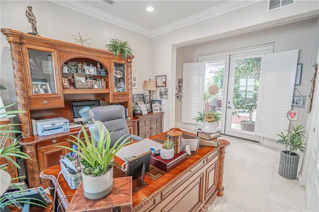 a utility room with stainless steel appliances a refrigerator and a window