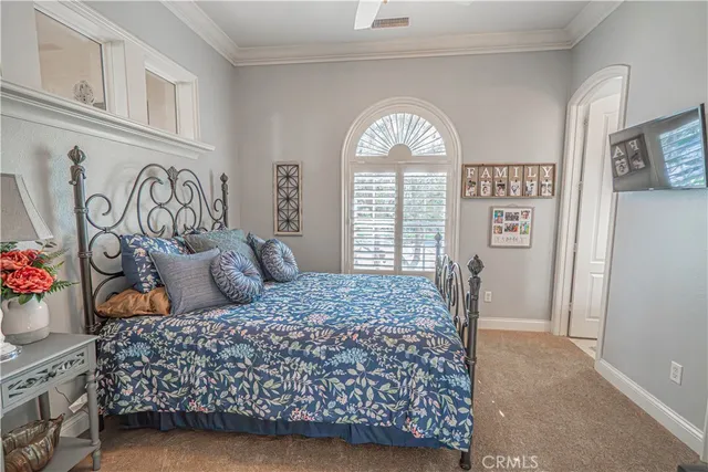 a spacious bedroom with a bed dresser and a window