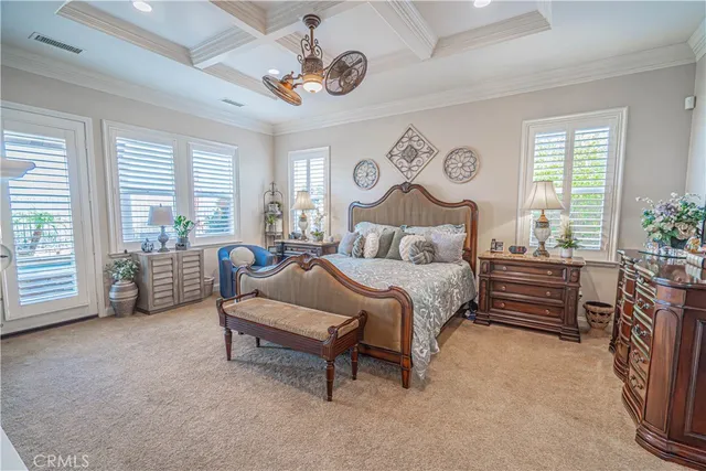 a living room with furniture a large window and wooden floor