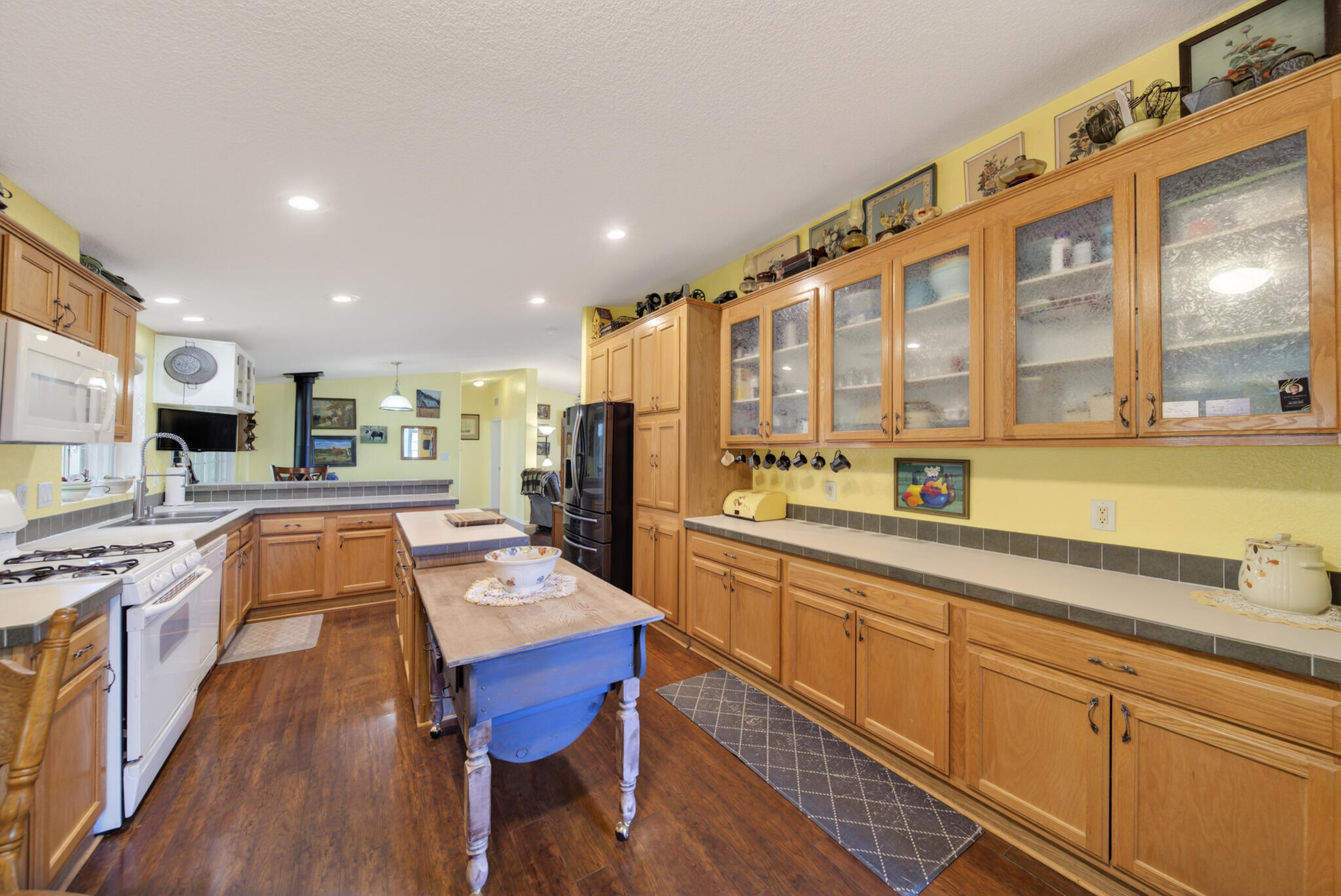 32017 Rock Creek Road Manton, CA 96059 - Photo 7 of 57 a kitchen with stainless steel appliances granite countertop a refrigerator a sink dishwasher a stove and white countertops with wooden floor