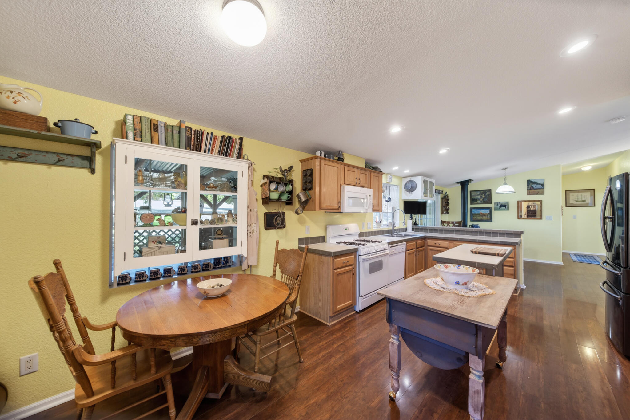 32017 Rock Creek Road Manton, CA 96059 - Photo 8 of 57 a living room with stainless steel appliances kitchen island granite countertop furniture and wooden floor