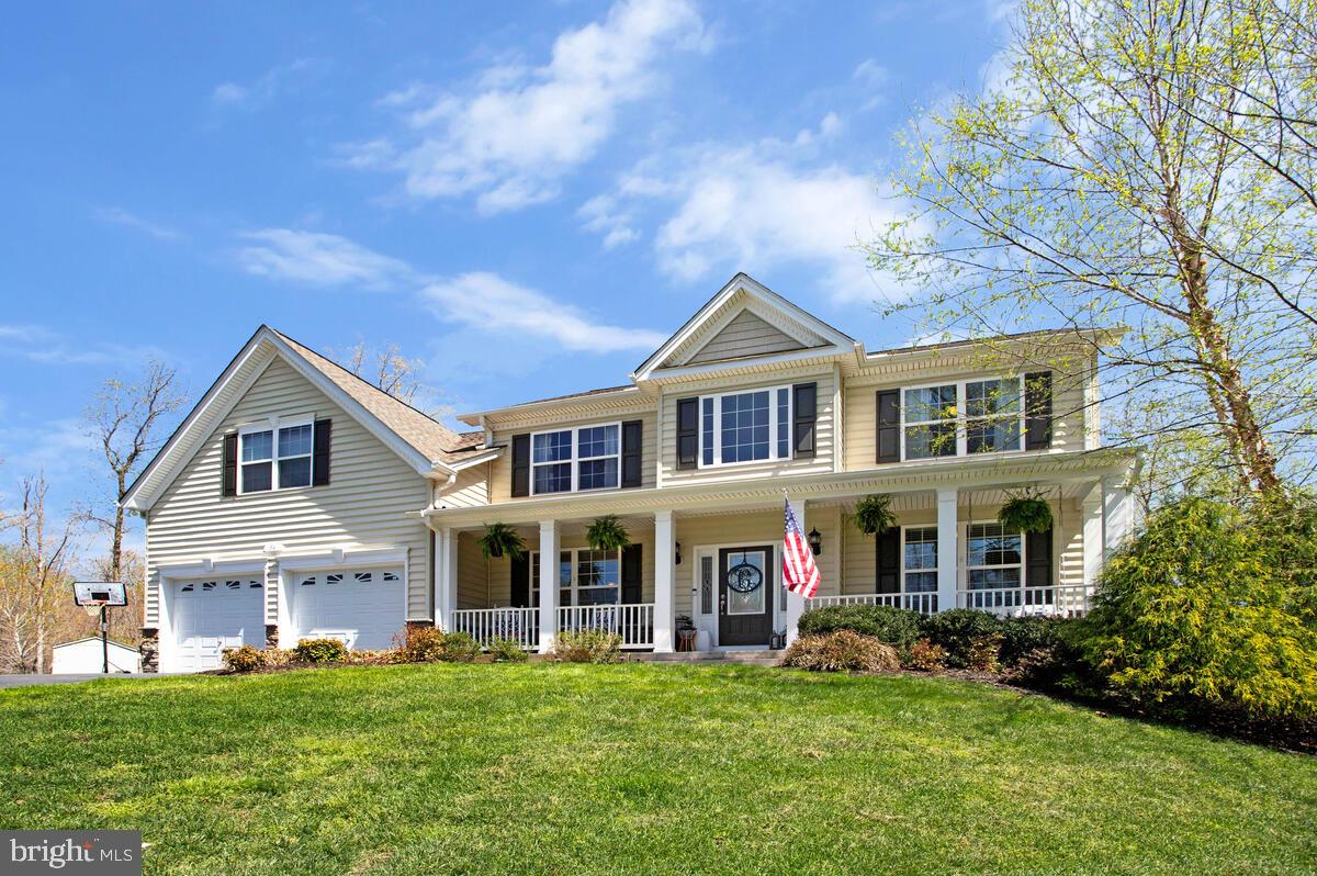 54 Simmons Ridge Road Prince Frederick, MD 20678 - Photo 3 of 55 a front view of a house with a garden