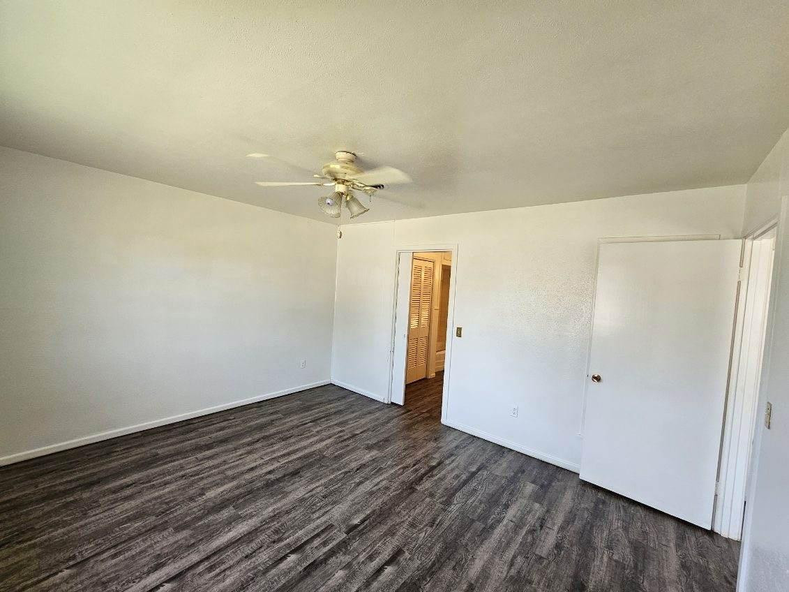 4201 50th Street, Unit A Lubbock, TX 79413 - Photo 5 of 7 wooden floor in an empty room