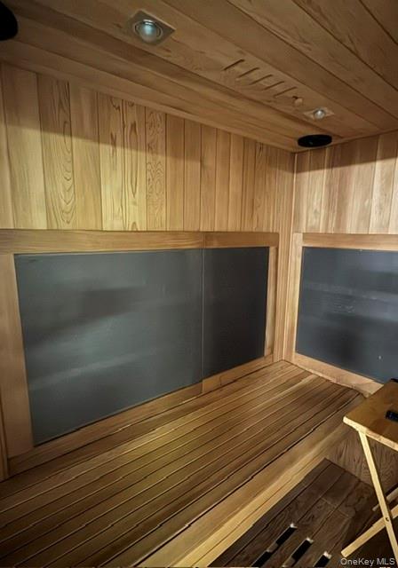 19 West Gate Road Suffern, NY 10901 - Photo 39 of 42 Custom sauna featuring wood paneling throughout, built-in wooden benches, recessed ceiling lighting, and integrated dark panel heating elements